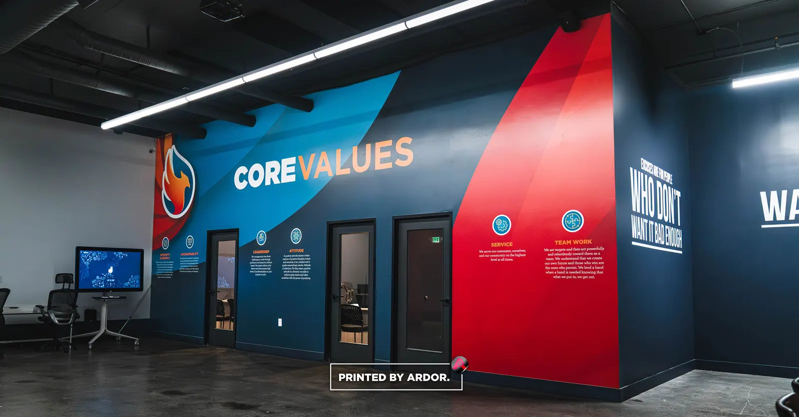 Navy, blue and red office wall wrap with "Core Values" lettering, icons and a flame graphic beside conference room doors